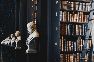Library with old books and busts of men